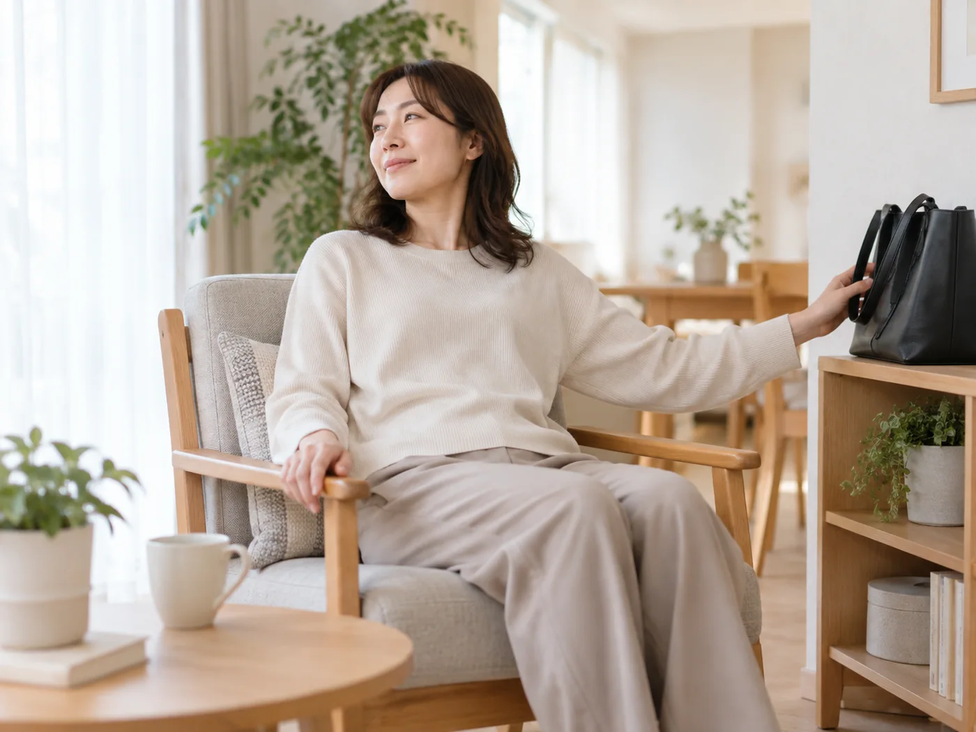 帰宅してバッグを置き椅子で一息つく女性のイメージ